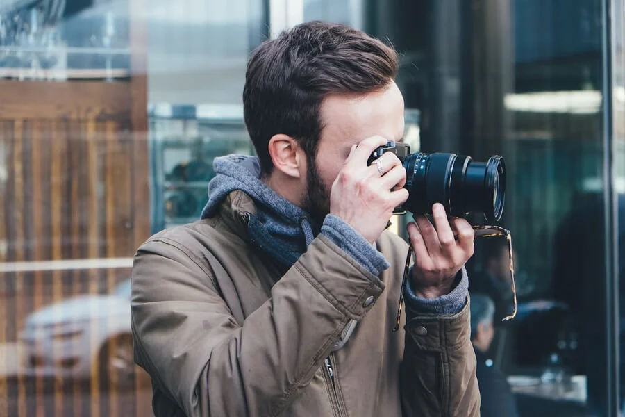 Photographer practicing camera skills to improve photography techniques and creativity