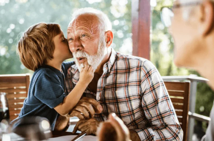 whispering secrets between grandfather and grandson, family photo ideas