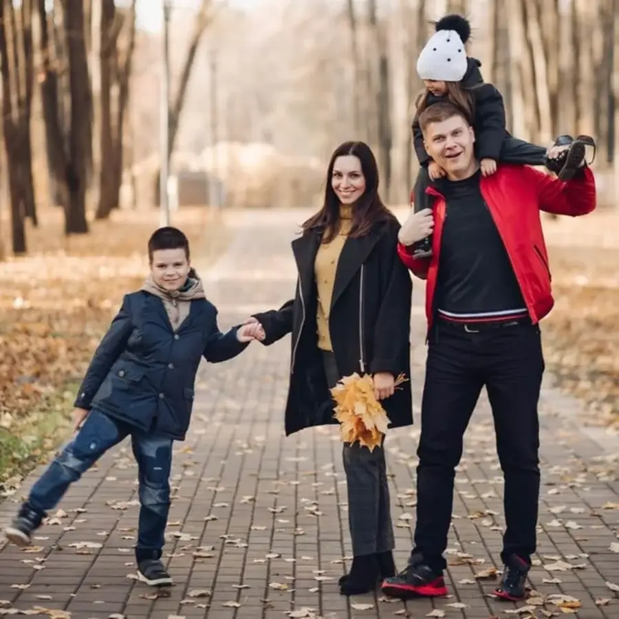 Family wearing coordinated black outfits for a modern, elegant photoshoot with a bold and timeless monochrome style.
